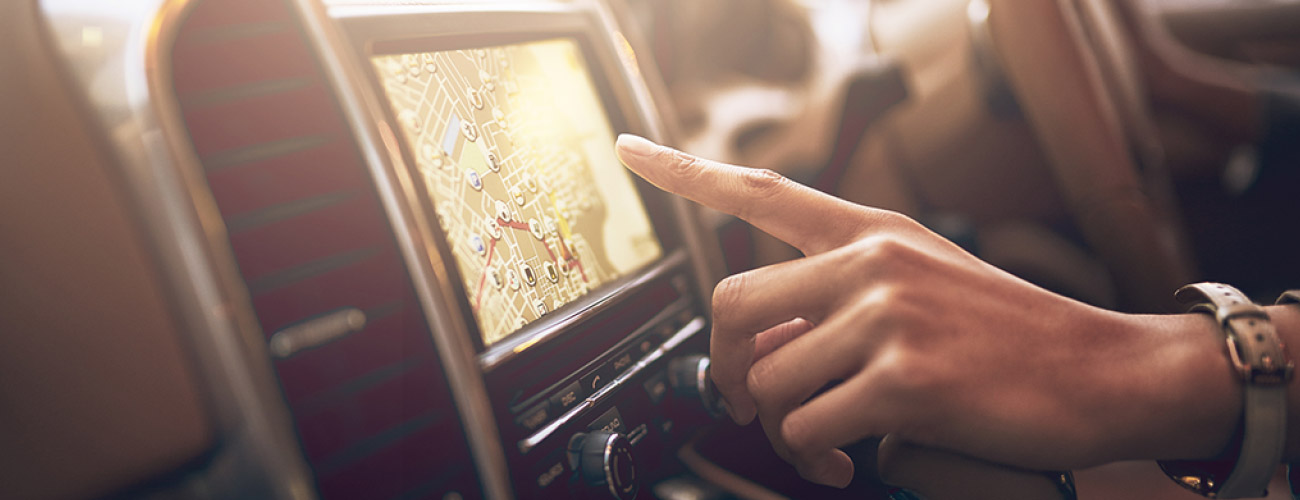 Person using navigation on vehicle dashboard